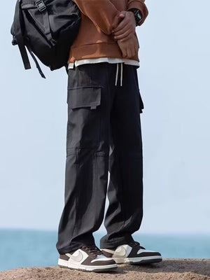Black relaxed fit cargo pants with flap pockets and drawstring waist.