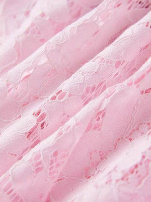 Powder pink floral lace dress detail showing intricate lace pattern and fabric texture.