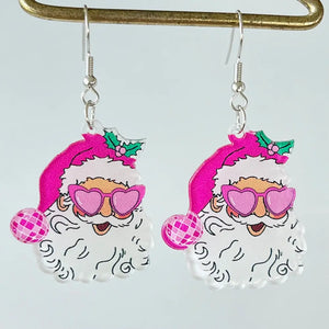 Festive acrylic Santa earrings with pink heart sunglasses and disco ball accents.