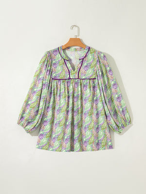 Paisley print blouse with puff sleeves and purple trim.