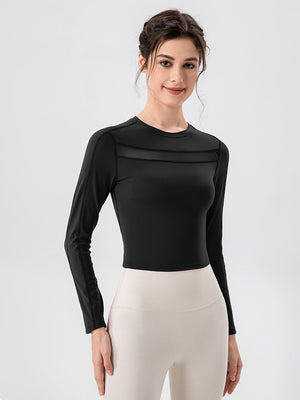 Black long sleeve crop top with mesh panel detail at the neckline
