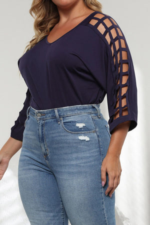 Dark navy v-neck blouse with lattice cut-out sleeves and 3/4 length sleeves.