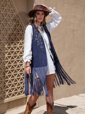 Navy faux suede vest with embroidered branches and long fringe detail.