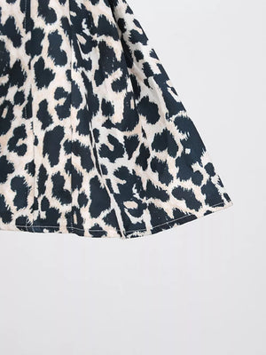 Leopard print mini dress with halter neck detail and cutout accents.