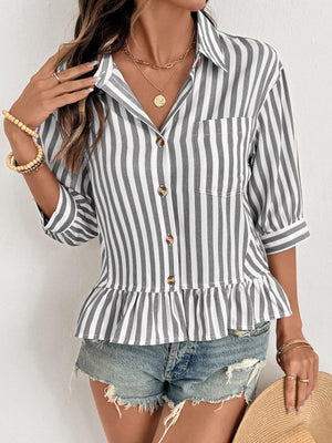 Striped button-down shirt with 3/4 sleeves and ruffle hem, styled with denim shorts.