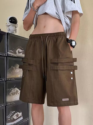 Brown cargo shorts with drawstring and double strap pocket details.