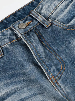 Men's blue wide leg jeans with vintage wash and button fly detail.