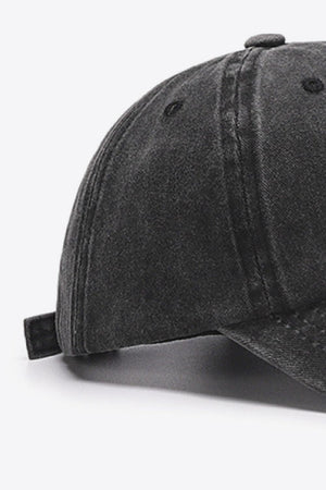 Washed cotton baseball cap in black with adjustable strap detail.