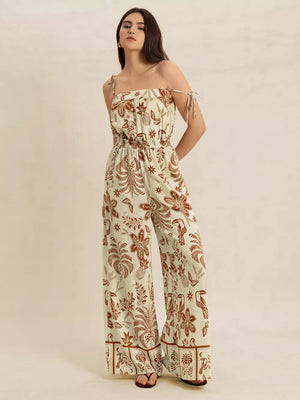 Tropical tie strap wide-leg romper in light green with brown floral and bird print.