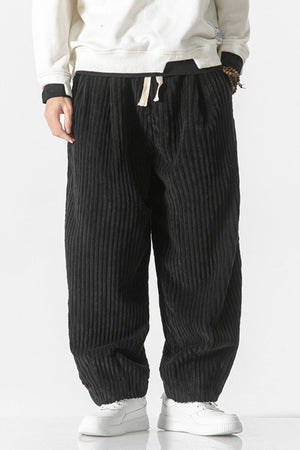 Black corduroy wide-leg cargo pants with drawstring waist and relaxed fit.