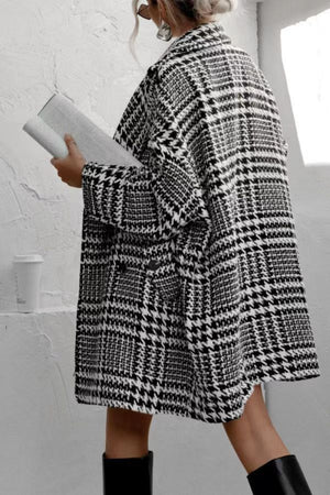 Black and white houndstooth oversized cocoon coat with lapels and pockets.