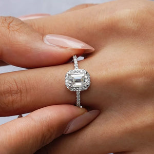 Radiant Moissanite engagement ring in silver with emerald cut center stone and diamond halo.