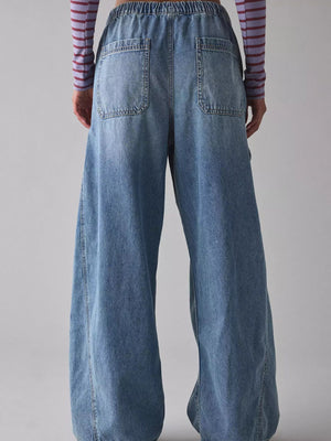 Drawstring waist cargo jeans in dusty blue denim with wide legs and back pockets.