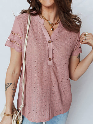 Pink eyelet embroidered short-sleeve blouse with button detail and v-neck.