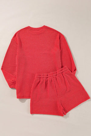 Textured red loungewear set with long sleeves and elastic waist shorts