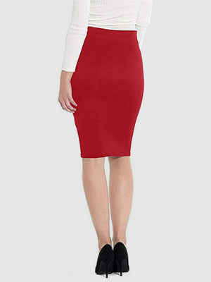 Red pencil skirt with a high waist and knee-length hem, styled with a white sweater and black heels.