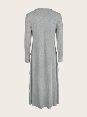 Light gray long sleeve midi dress with asymmetrical tiered hem and pockets.