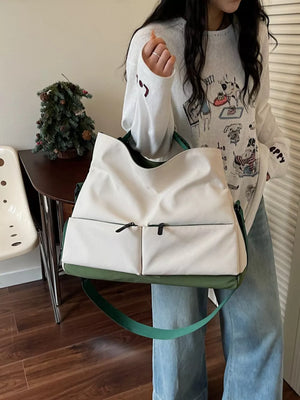 Premium Oxford cloth travel bag in ivory with green accents and two front zip pockets.