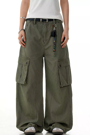Olive green wide-leg cargo pants with large side pockets and a relaxed fit.