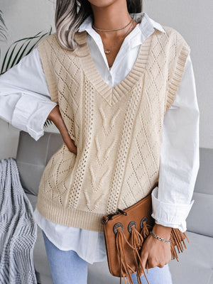 Cream openwork cable knit vest with V-neck and diamond pattern, styled over a white shirt.