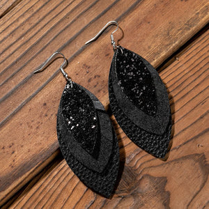 Black layered faux leather statement earrings with glitter detail