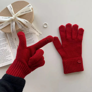 Luxurious wool knit gloves in deep red with ribbed cuffs and button detail.