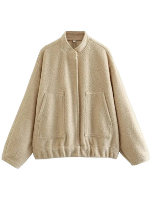 Beige boucle cocoon jacket with snap closure and two front pockets.