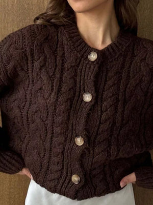 Brown cable-knit button-down cardigan with round neckline and cream buttons.