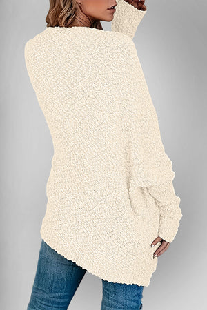 Cream popcorn knit open cardigan with textured fabric and long sleeves.