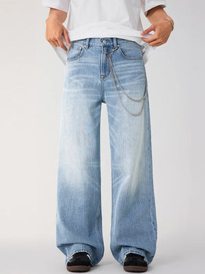 Men's light wash wide-leg jeans with chain detail and faded wash.