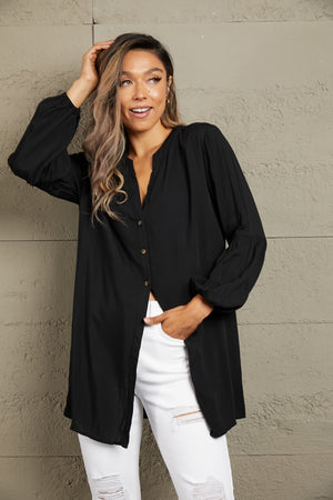 Black oversized blouse with mandarin collar, button front, and balloon sleeves.