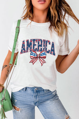 White graphic tee with AMERICA text and patriotic bow motif.