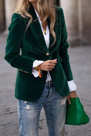 Green velvet blazer with gold button detail, lapel collar, and cuffed sleeves.
