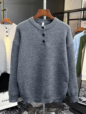 Plus-size gray knit sweater with button detail and crew neck.