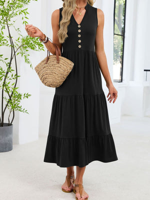 Black tiered midi dress with V-neck and decorative buttons, sleeveless.