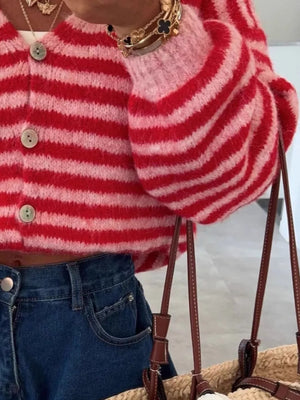 Charming cropped red and pink striped knit cardigan with balloon sleeves and button front.