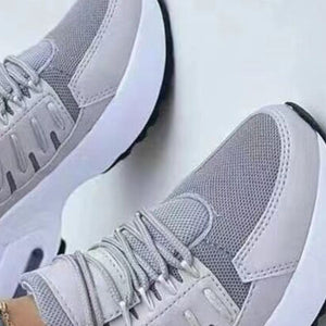 Grey lace-up chunky platform sneakers with mesh and faux leather details.