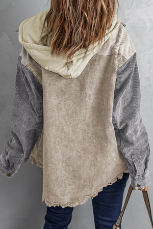 Colorblock corduroy hooded utility jacket in tan and gray with frayed hem.