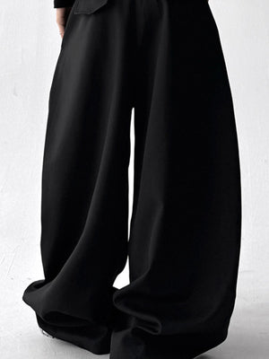 Men's black wide leg drawstring sweatpants with a relaxed fit.