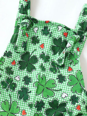 Green plaid overalls with shamrock and heart print, featuring knotted shoulder straps.