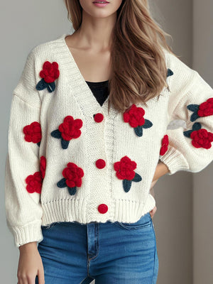 Cream knit cardigan with red rose appliqués and button front.