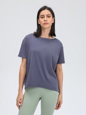 Relaxed fit performance tee in dusty blue with short sleeves and a boat neck.
