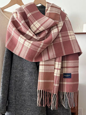 Pink plaid scarf with fringe and cream accents, featuring a classic tartan pattern.