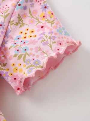 Pastel floral print cotton dress with ruffled sleeves and hem.
