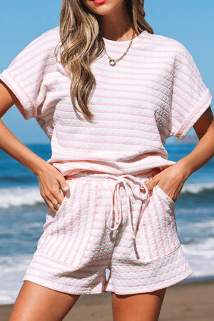Textured stripe lounge set in blush pink with drawstring shorts and short sleeve top.
