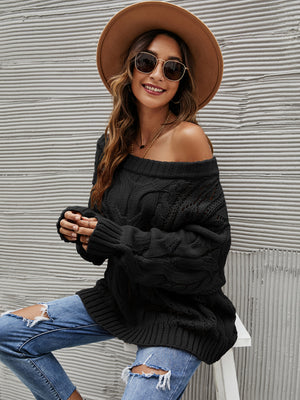Black cable knit off-shoulder slouch sweater with a relaxed fit.