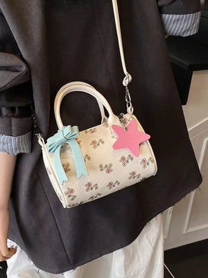 Charming floral mini crossbody bag with blue bow and pink star charm