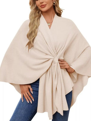 Eggshell knit cape top with tie-front and draped elegance, V-neck, wide sleeves.