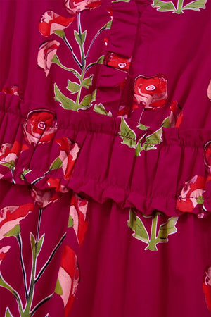 Charming floral tiered midi dress in magenta with red roses and green leaves, featuring ruffled tiers.