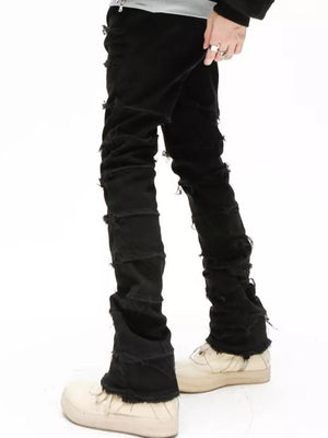 Black cotton jeans for men with frayed hem and distressed details.
